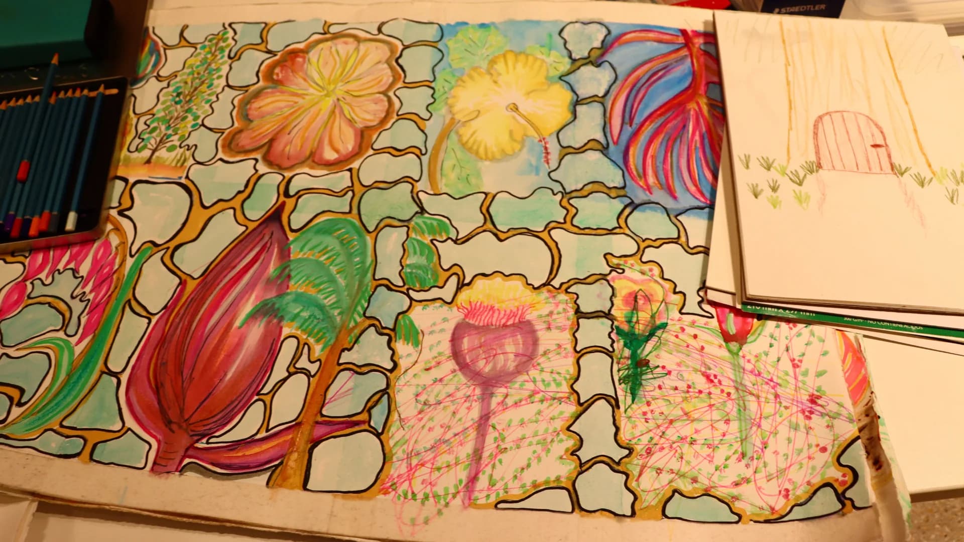 A large, colourful group drawing of flowers made during an Art of Wellness session